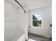 Bright bathroom with a bathtub, large window providing natural light and outdoor views at 1308 Austin Chaney Rd, Wingate, NC 28174