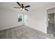 Well-lit bedroom features a ceiling fan, closet, plush carpeting, and a window with a view of the outdoors at 1308 Austin Chaney Rd, Wingate, NC 28174