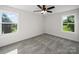 Bright and airy bedroom with a ceiling fan, plush carpet, and large windows offering scenic outdoor views at 1308 Austin Chaney Rd, Wingate, NC 28174