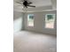 A well-lit bedroom with tray ceiling, large windows, and neutral walls is ready for your personal touch at 1308 Austin Chaney Rd, Wingate, NC 28174