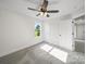 Well-lit bedroom featuring neutral walls, carpeted floors, a ceiling fan, and a scenic window view at 1308 Austin Chaney Rd, Wingate, NC 28174