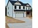Charming two-story home with black roof, white siding, and attached garage at 1308 Austin Chaney Rd, Wingate, NC 28174