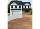 Charming two-story home with black roof, white siding, and attached garage at 1308 Austin Chaney Rd, Wingate, NC 28174