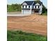 Charming two-story home with black roof, white siding, and attached garage at 1308 Austin Chaney Rd, Wingate, NC 28174