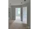 Hallway featuring three doors that provide access to other rooms in the home at 1308 Austin Chaney Rd, Wingate, NC 28174