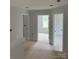Open hallway featuring three doors that provide access to other rooms in the home at 1308 Austin Chaney Rd, Wingate, NC 28174