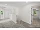 Well-lit hallway featuring neutral walls, carpeted floors, and doorways to other rooms at 1308 Austin Chaney Rd, Wingate, NC 28174