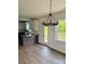 The kitchen with a granite countertop, stainless appliances, dark cabinets is open to the dining area and outdoor deck at 1308 Austin Chaney Rd, Wingate, NC 28174