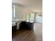 The kitchen has granite countertops, stainless appliances, dark base cabinets and is open to the dining area at 1308 Austin Chaney Rd, Wingate, NC 28174