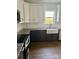 Modern kitchen with white cabinets, granite countertops, and stainless steel appliances at 1308 Austin Chaney Rd, Wingate, NC 28174