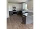 A modern kitchen featuring white cabinets, granite countertops, stainless steel appliances, and an apron-front sink at 1308 Austin Chaney Rd, Wingate, NC 28174
