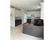 An unfinished kitchen featuring white upper cabinets, dark lower cabinets, and a center island at 1308 Austin Chaney Rd, Wingate, NC 28174
