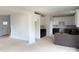 An unfinished kitchen featuring white upper cabinets, dark lower cabinets, and a center island at 1308 Austin Chaney Rd, Wingate, NC 28174
