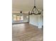Bright living room with large window, ceiling fan, and beautiful flooring at 1308 Austin Chaney Rd, Wingate, NC 28174