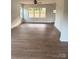 Bright living room with large window, ceiling fan, and beautiful flooring at 1308 Austin Chaney Rd, Wingate, NC 28174