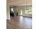 Open-concept living room leading to kitchen with bright windows at 1308 Austin Chaney Rd, Wingate, NC 28174