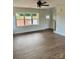 Bright living room with large window, ceiling fan, and beautiful flooring at 1308 Austin Chaney Rd, Wingate, NC 28174