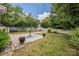 This backyard has a brick patio with a table and chairs. The backyard is surrounded by a white picket fence at 14105 Garden District Row, Huntersville, NC 28078