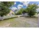 This backyard has a brick patio, grass, and a white picket fence between the houses at 14105 Garden District Row, Huntersville, NC 28078