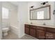 Functional bathroom featuring a double sink vanity, tiled floors, and a shower-tub combo at 14105 Garden District Row, Huntersville, NC 28078