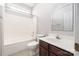 This bathroom has a tiled shower-tub, a toilet, and a dark wood vanity with a white sink at 14105 Garden District Row, Huntersville, NC 28078