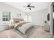 Bright bedroom with two windows, a ceiling fan, and a cozy neutral color scheme at 14105 Garden District Row, Huntersville, NC 28078