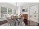 Inviting dining area with a round table, stylish chairs, a modern chandelier, and ample natural light at 14105 Garden District Row, Huntersville, NC 28078
