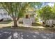 Charming yellow home with a large porch, perfect for enjoying the outdoors in a quiet neighborhood at 14105 Garden District Row, Huntersville, NC 28078