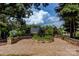 Scenic garden area with stone accents and lush greenery under a canopy of trees at 14105 Garden District Row, Huntersville, NC 28078