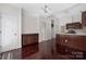 Open-concept layout featuring wood floors, a buffet, and a kitchen island at 14105 Garden District Row, Huntersville, NC 28078