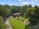 Sprawling property with lush greenery, mature trees, and a well-manicured lawn at 14415 Old Beatty Ford Rd, Gold Hill, NC 28071