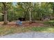 Spacious backyard featuring mature trees, storage sheds, and a picnic area at 14415 Old Beatty Ford Rd, Gold Hill, NC 28071