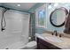 Bathroom with walk-in shower, vanity, and a round mirror at 14415 Old Beatty Ford Rd, Gold Hill, NC 28071