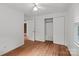 Bright bedroom featuring hardwood floors, closet, and a ceiling fan at 14415 Old Beatty Ford Rd, Gold Hill, NC 28071