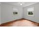 A well-lit room featuring hardwood floors and two windows offering natural light at 14415 Old Beatty Ford Rd, Gold Hill, NC 28071