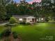 Charming brick home with a well-maintained front lawn and mature trees at 14415 Old Beatty Ford Rd, Gold Hill, NC 28071