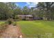 Traditional home featuring a large, green front lawn with lovely landscaping details at 14415 Old Beatty Ford Rd, Gold Hill, NC 28071