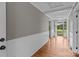 Elegant hallway featuring hardwood floors, white wainscoting, and neutral wall color at 14415 Old Beatty Ford Rd, Gold Hill, NC 28071