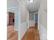 Hallway with hardwood flooring, wainscotting, and access to rooms at 14415 Old Beatty Ford Rd, Gold Hill, NC 28071