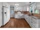 Bright kitchen with white cabinets, granite countertops, stainless appliances, and hardwood floors at 14415 Old Beatty Ford Rd, Gold Hill, NC 28071