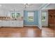 Kitchen features white cabinetry, granite countertops, dishwasher, hardwood flooring and natural light at 14415 Old Beatty Ford Rd, Gold Hill, NC 28071