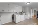 Laundry room with washer, dryer, and overhead cabinets at 14415 Old Beatty Ford Rd, Gold Hill, NC 28071