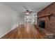 Spacious living room featuring hardwood floors and a cozy brick fireplace at 14415 Old Beatty Ford Rd, Gold Hill, NC 28071