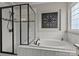 Relaxing bathroom with a soaking tub, separate shower, and tiled surround at 16034 Rushwick Dr, Huntersville, NC 28078