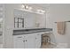 Bathroom featuring a granite countertop, vanity with white cabinets, a stool, and a large mirror at 16034 Rushwick Dr, Huntersville, NC 28078