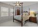 Comfortable bedroom with a four-poster bed and natural light from two windows at 16034 Rushwick Dr, Huntersville, NC 28078