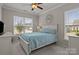 Bedroom with a queen-size bed, comfortable blue quilt, and natural light from the window at 16034 Rushwick Dr, Huntersville, NC 28078