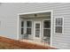 Cozy covered patio with two chairs, offering a relaxing outdoor space at 16034 Rushwick Dr, Huntersville, NC 28078