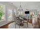 Cozy dining area with a round table, hardwood floors, and lots of natural light at 16034 Rushwick Dr, Huntersville, NC 28078