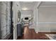 Elegant foyer with hardwood floors, a decorative mirror, and a view into the open-concept living area at 16034 Rushwick Dr, Huntersville, NC 28078